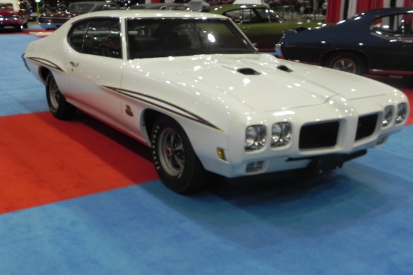 blurry picture of a white pontiac gto judge