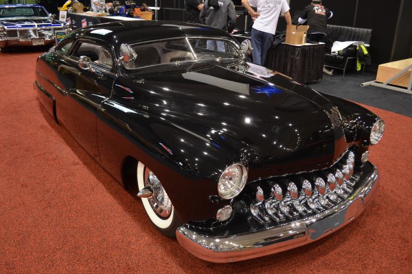custom chopped mercury lead sled hotrod on display at indoor car show