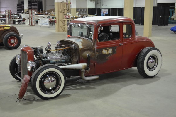 vintage ford five window hotrod on display at indoor car show