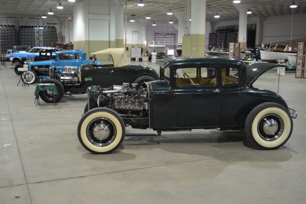 rows of hot rods on display at indoor car show