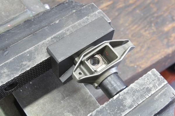 pressing a bearing into a trunnion with a bench vise