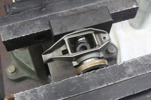 pressing trunnion into a rocker arm with a bench vise