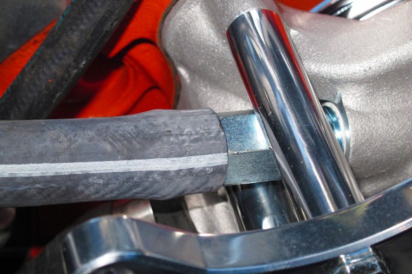 installing heater hoses into a water pump