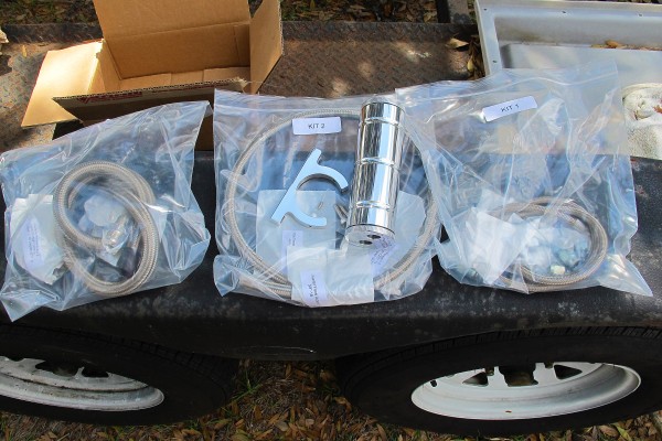 power steering system parts in bags on a fender
