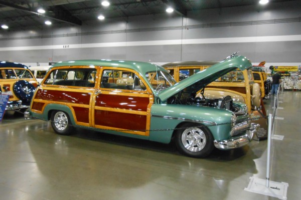 old school woody wagon displayed at indoor car show