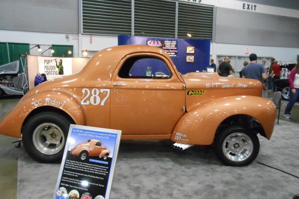 vintage gasser hot rod displayed at indoor car show