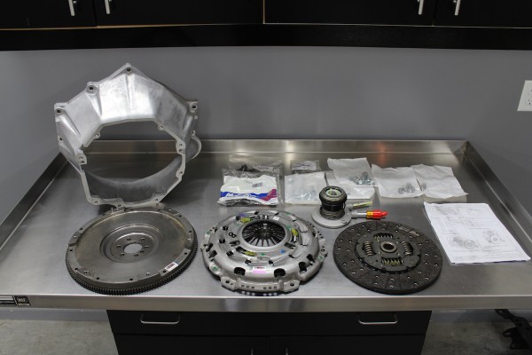 clutch, bellhousing, and flywheel parts on a workbench