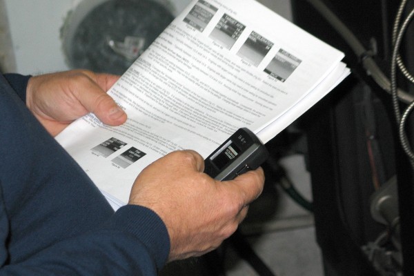 man holding control module and instructions