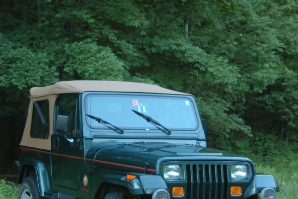 jeep wrangler yj parked in grassy field