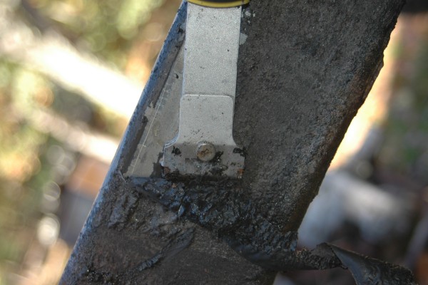 scraping gunk and crud from a jeep wrangler frame