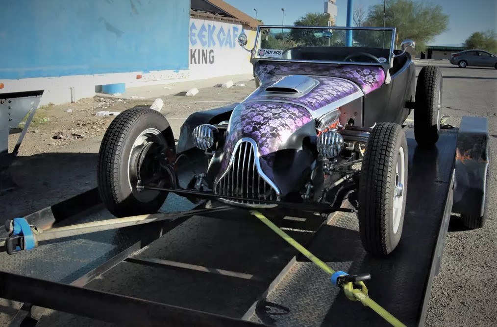 vintage hot rod on an open race car trailer
