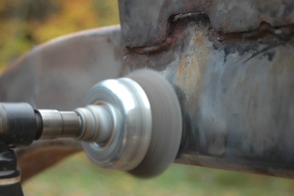 removing paint from a vehicle frame using a wire wheel