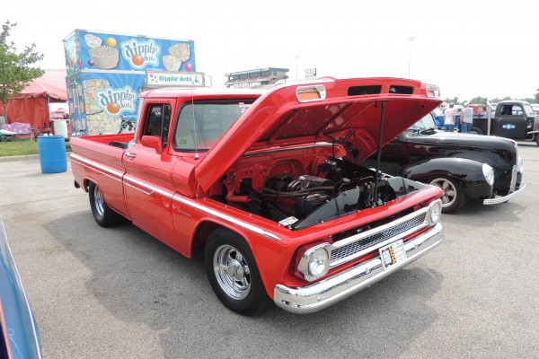 red classic pickup truck at a car show