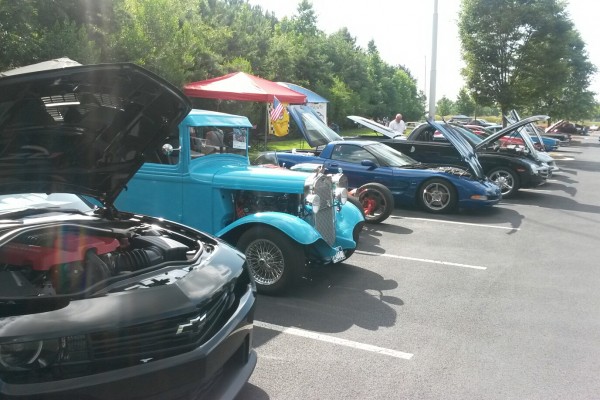 row of classic cars at a show