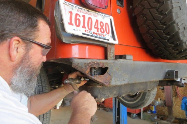 hammering bolts out of a jeep bumper