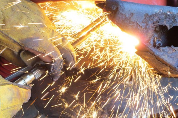 cutting bolts with torch and sparks from a rear bumper