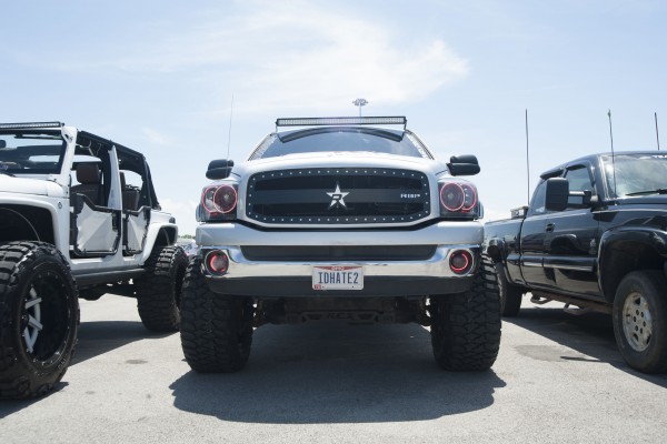 lifted pickup trucks and suvs at a car show