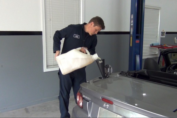 man filling an ls swapped miata with fuel