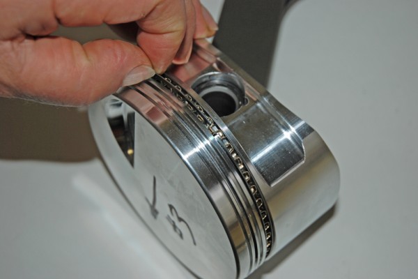 fitting a piston ring into a piston head groove