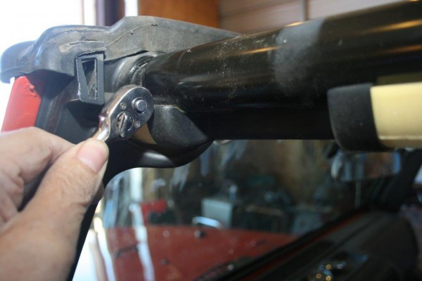 tightening a bolt on a roll cage