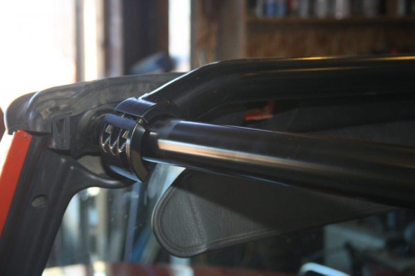 jeep crossbar getting mounted on an aftermarket roll bar