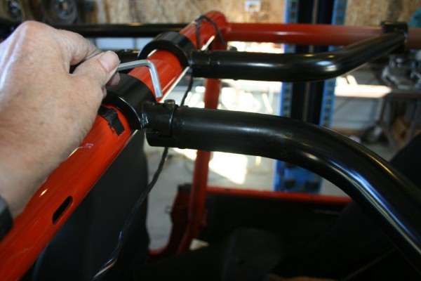 tightening bolts on a jeep wrangler roll cage upgrade
