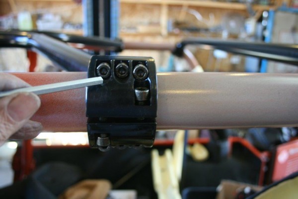tightening bolts on a roll cage mount bracket