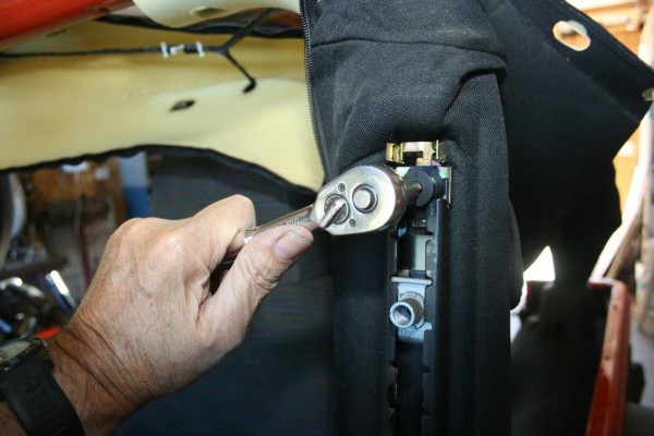 man bolting down roll cage bracket