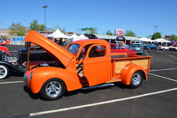 vintage orange hot rod pickup truck at car show