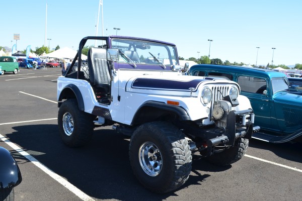 vintage cj5 jeep off roader at a car show parking lot