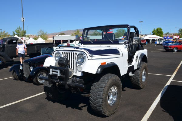 vintage cj5 jeep off roader at a car show parking lot