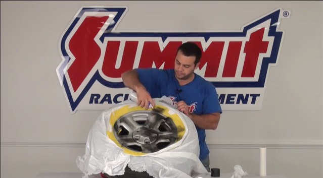 man painting wheel during demo