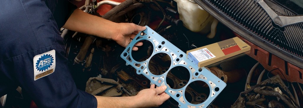 man installing fel pro engine cylinder head gasket