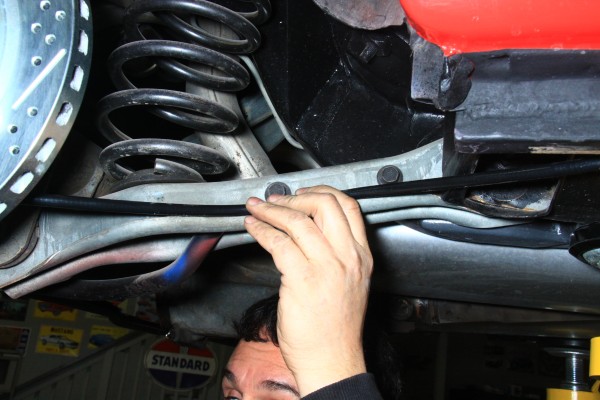 running parking brake cable along a vehicle trailing arm