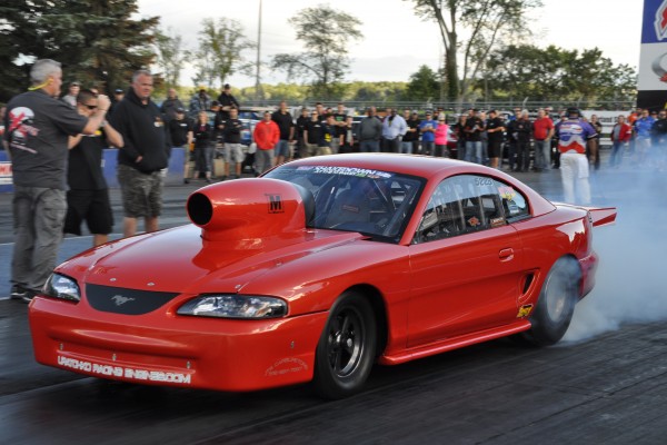 sn95 ford mustang dragster doing a burnout
