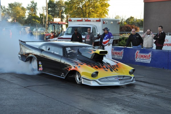 modified chevy bel air drag car doing a burnout