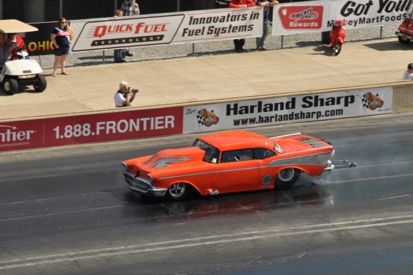 modified 1957 chevy bel air drag car doing a burnout