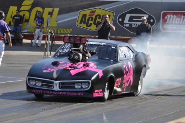a modified pontiac firebird pro mod car doing a burnout