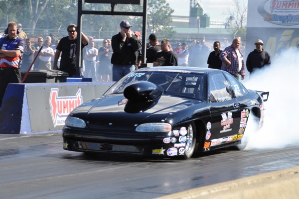 a chevy pro stock car doing a burnout