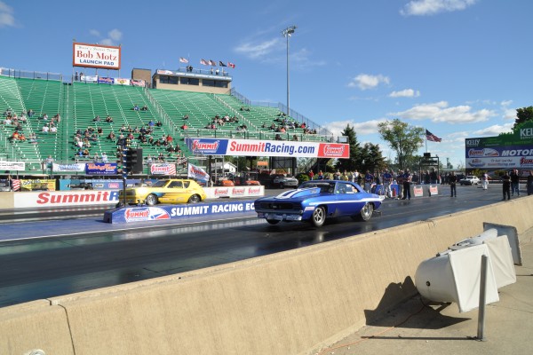 an amc gremlin and chevy camaro launching at dragstrip