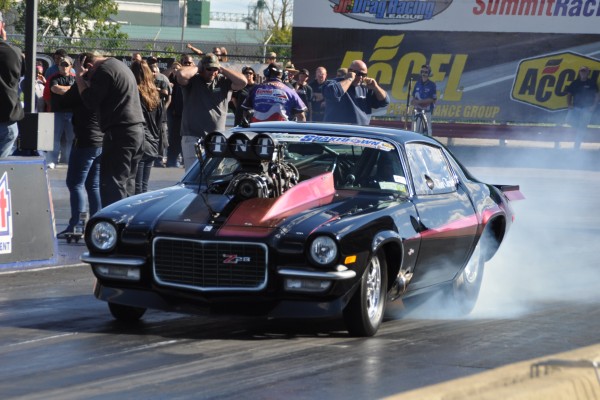 a split bumper z28 camaro pro mod launching at dragstrip