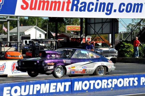 a ford mustang ii drag car launching at dragstrip
