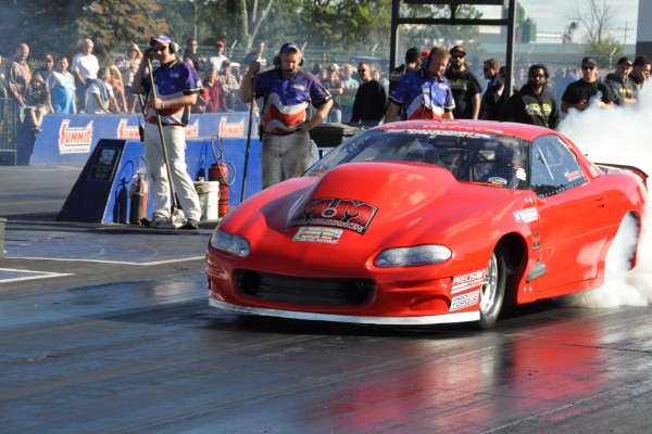 chevy camaro drag car doing a burnout at dragstrip