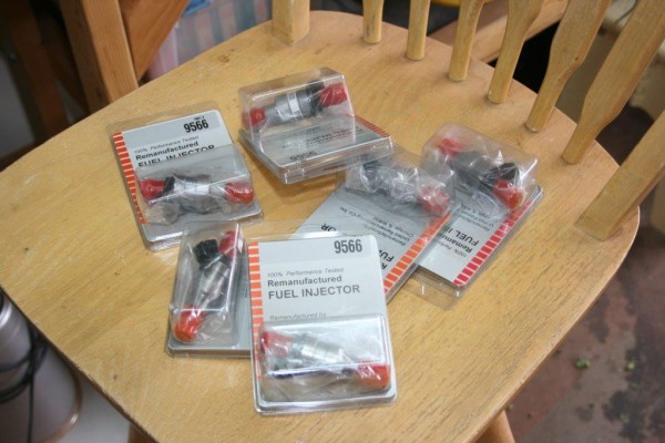 new remanufactured fuel injectors on a wooden chair