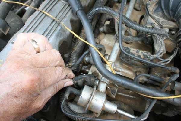 disconnecting vacuum lines from a fuel injector rail