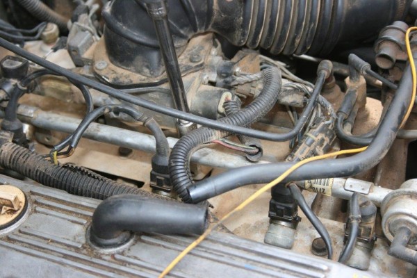 a large socket wrench extension on an engine part