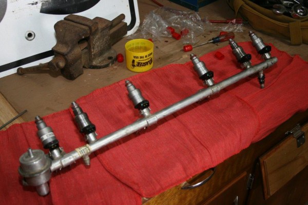 new injectors being installed into a fuel rail