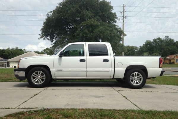 side profile view of a white chevy Silverado truck