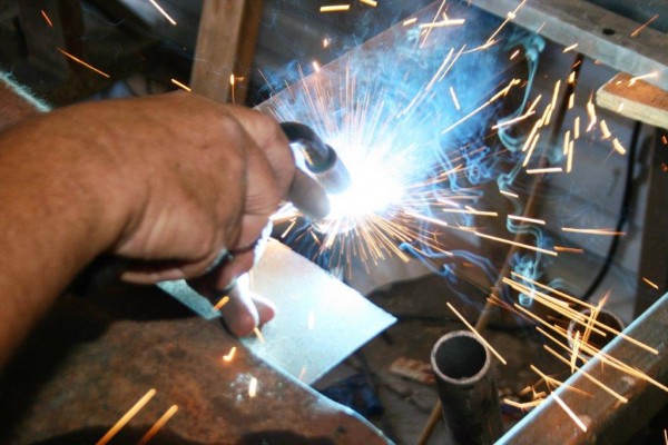 man welding on a car part