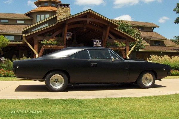 black 1968 dodge charger restomod at golf course